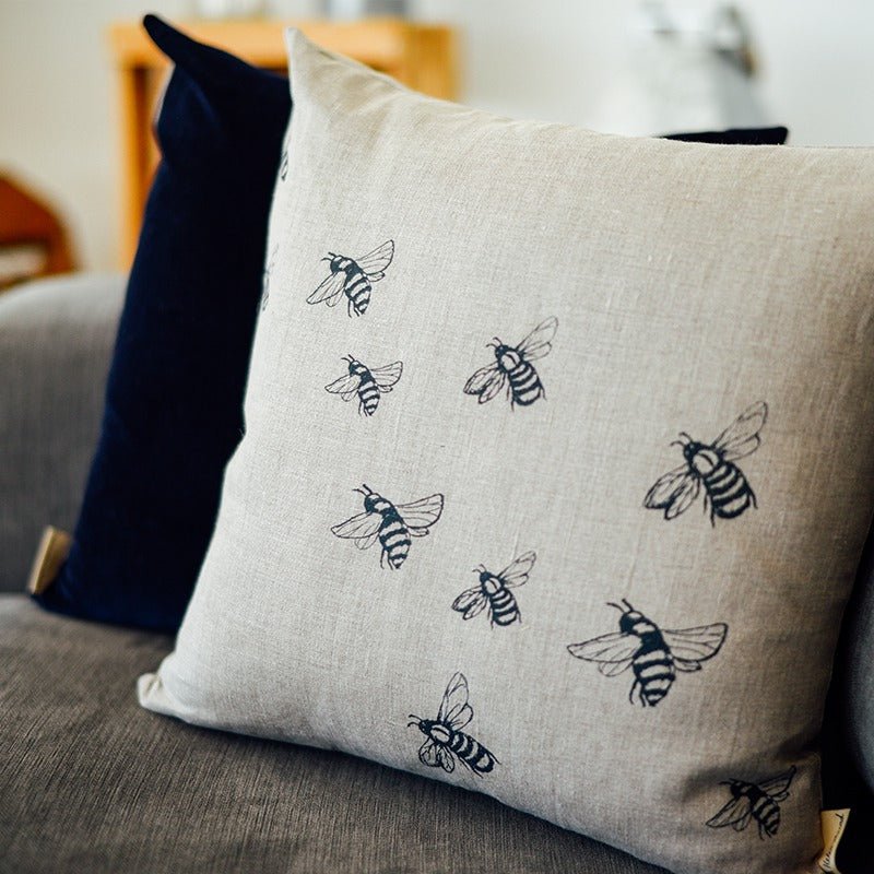 Natural linen bee cushion with navy velvet back. Printed in blue from the Bee Collection by Helen Round