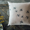 Bee cushion in natural linen with printed bee design in blue. From the Bee Collection by Helen Round