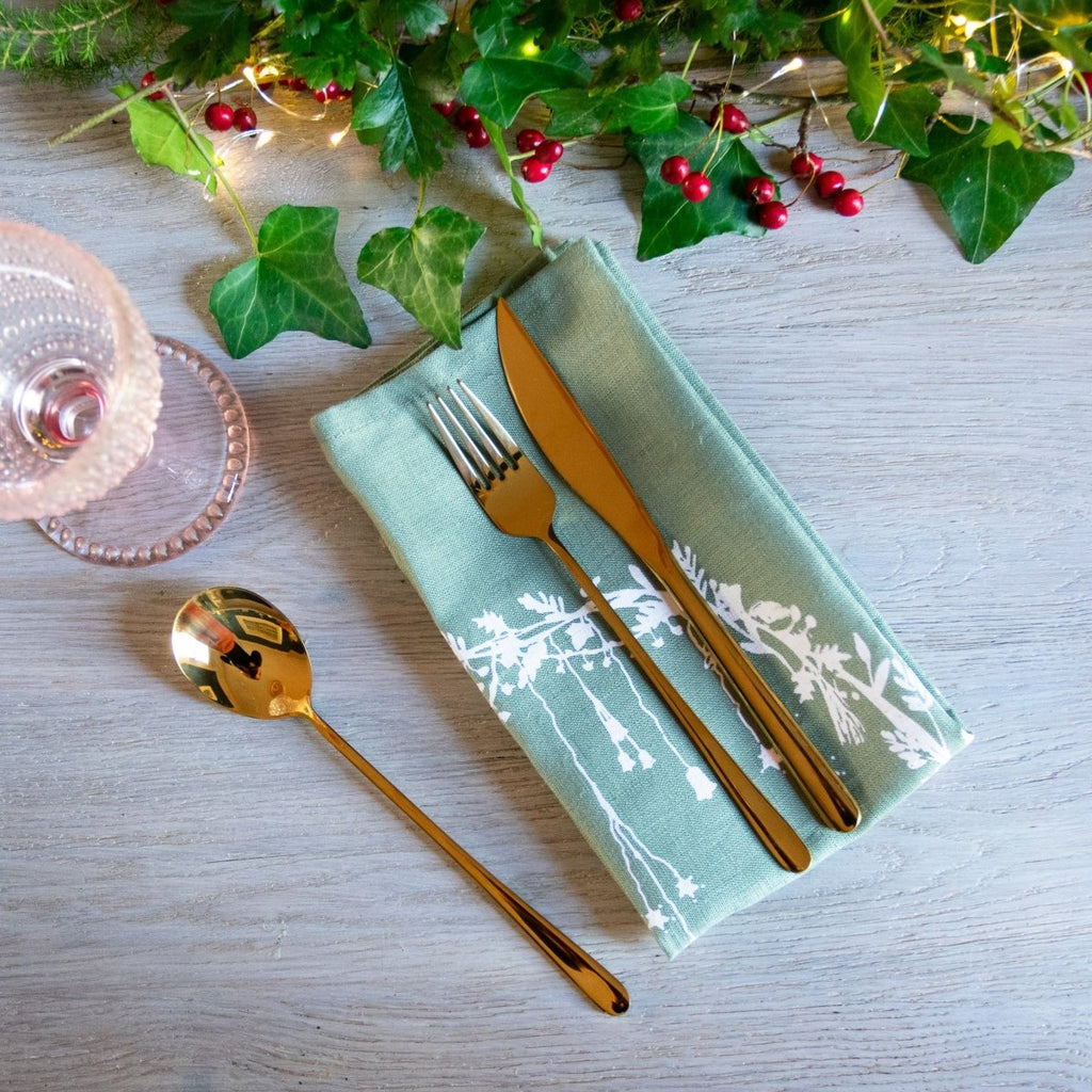sage green linen Christmas napkins with holly and ivy design