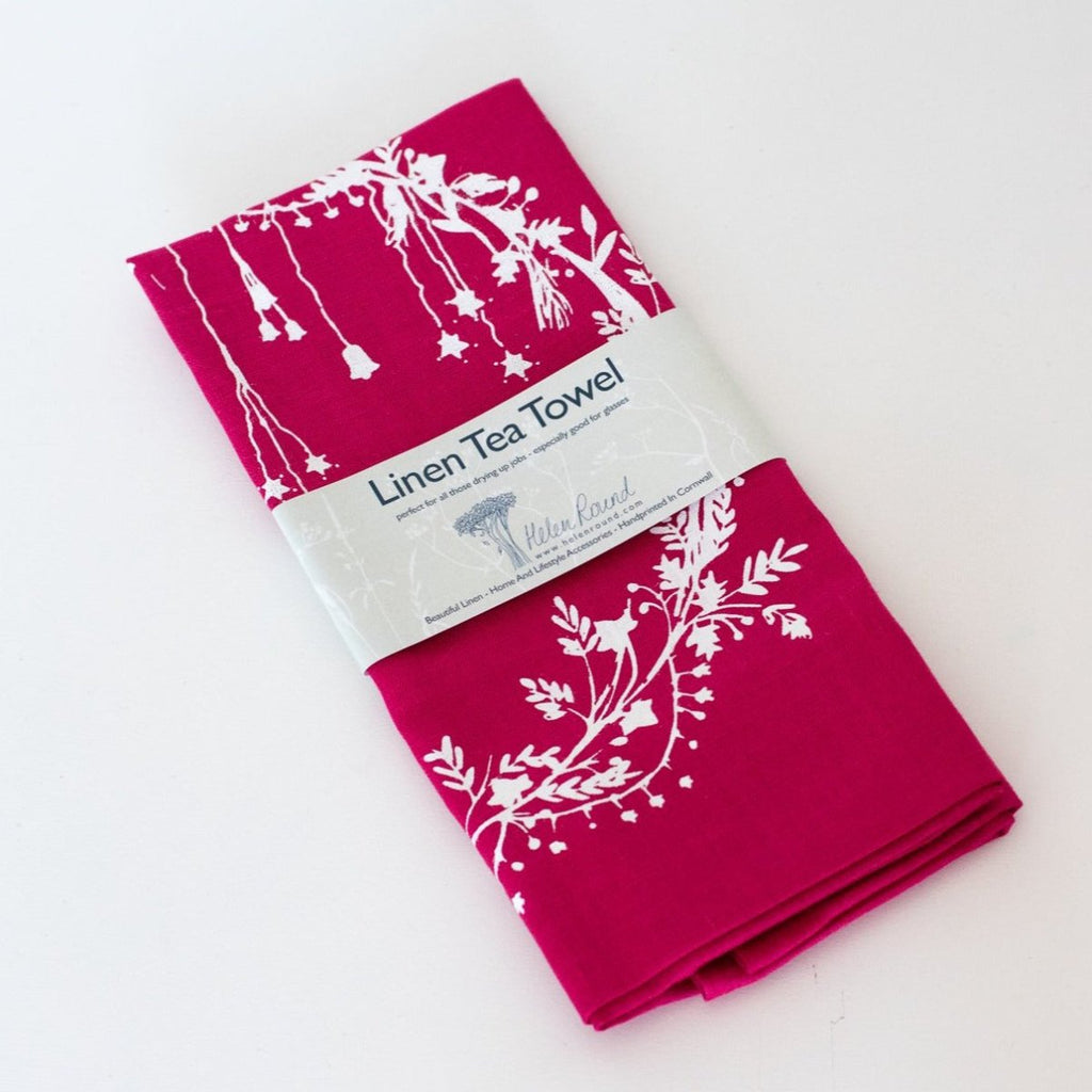 raspberry red linen Christmas tea towel with holly and ivy print