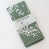 sage green linen Christmas tea towel with holly and ivy print