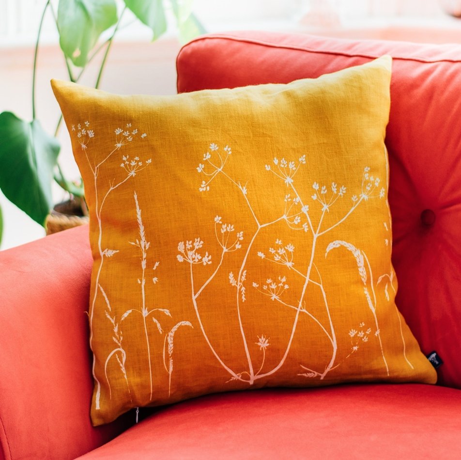 Floral cushion in mustard pure linen hand printed in white with the design from the Hedgerow Collection by Helen Round