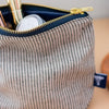 Striped Linen MakeUp Bag in Dark Blue/Natural Fine Stripes with splash proof lining and brass zip from the Striped Collection by Helen Round