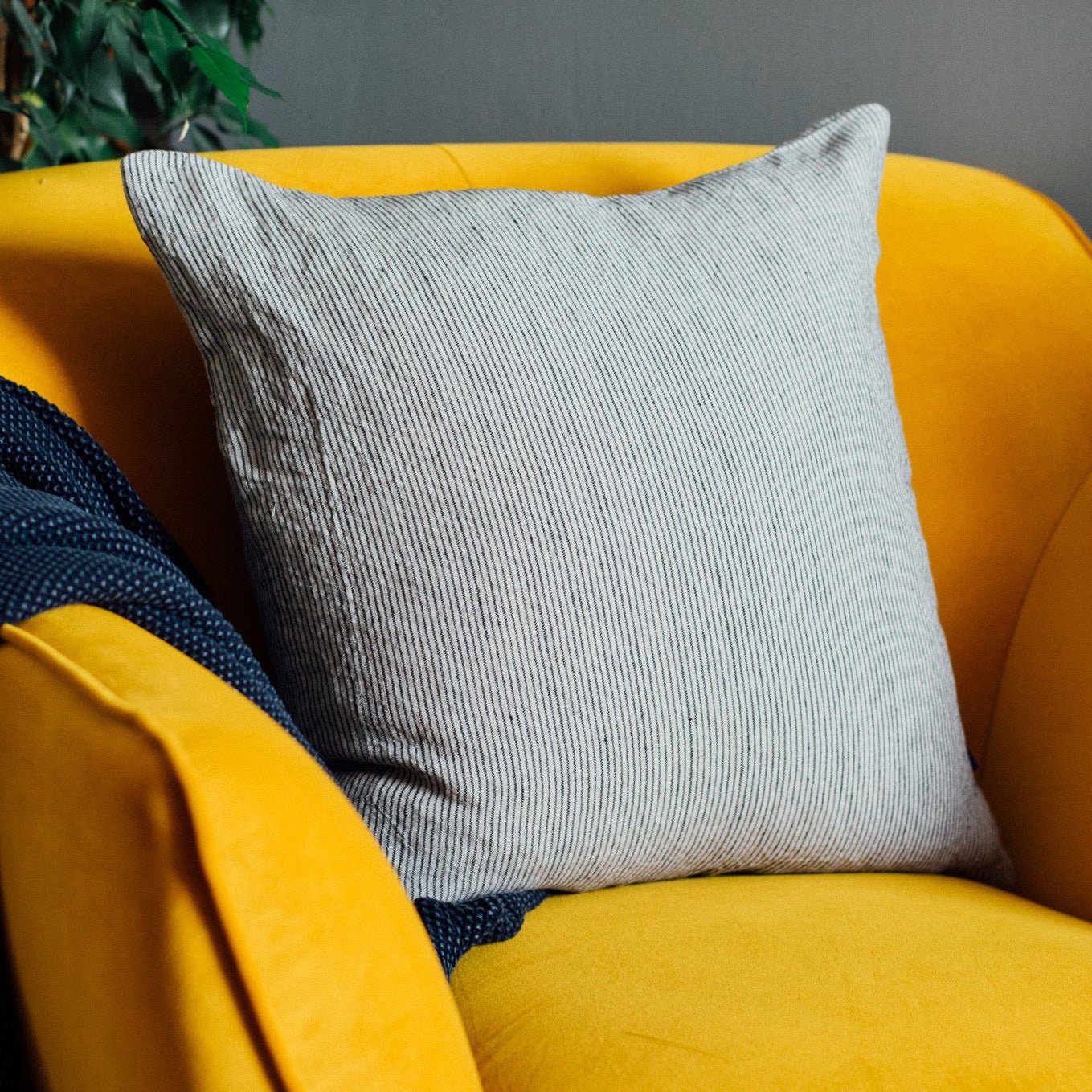 Natural striped Linen Cushion With Navy Blue/Natural Stripes on mustard yellow chair