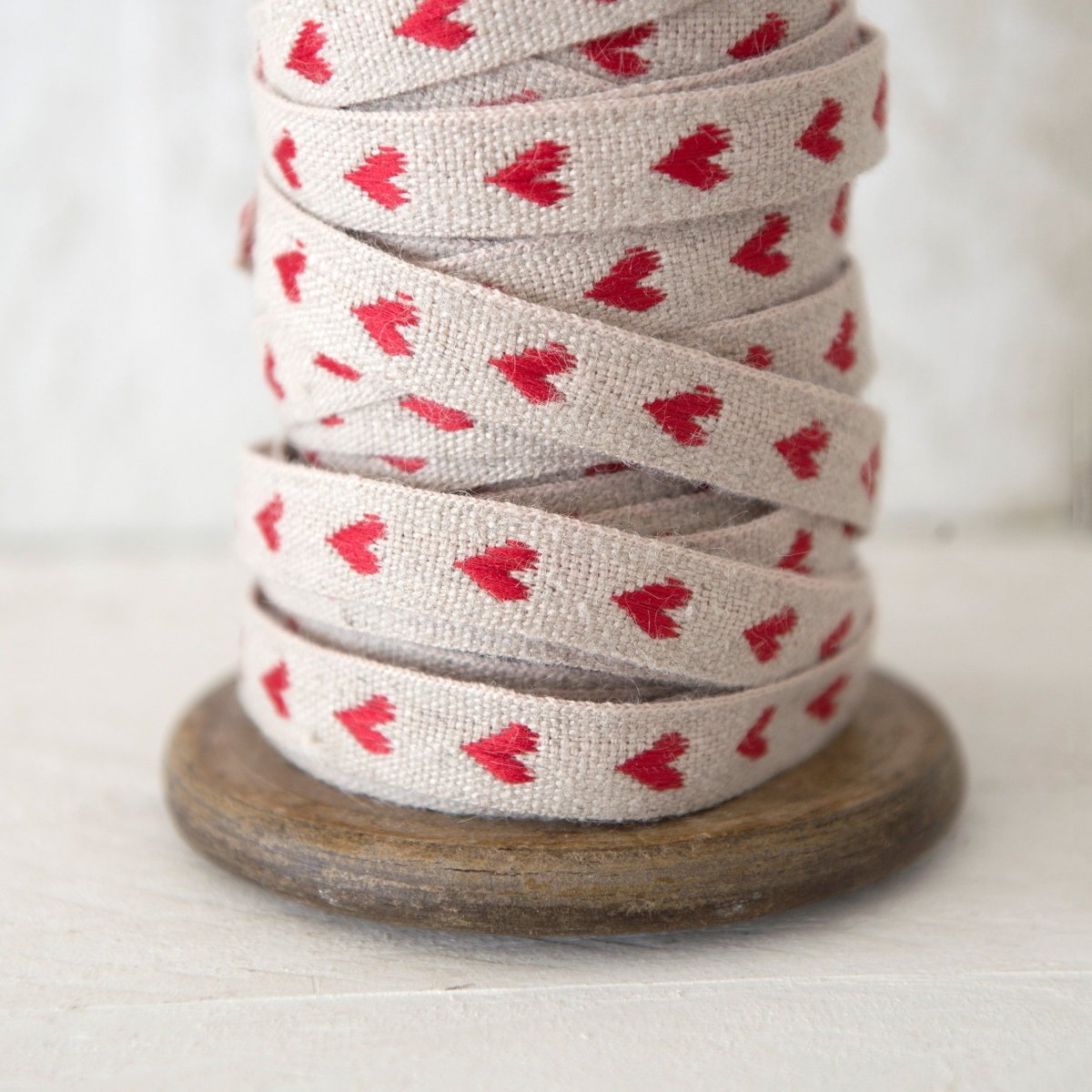 helen round haberdashery linen ribbon with red hearts on natural linen